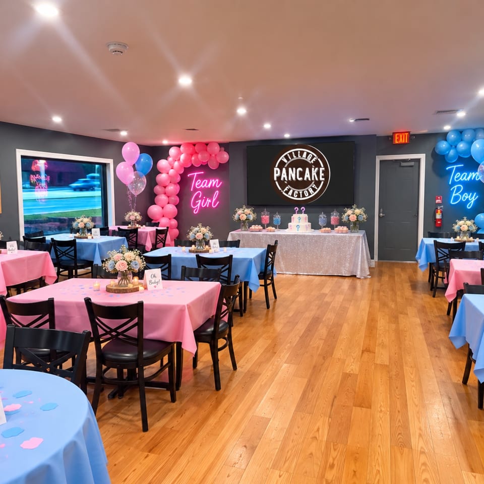 Village Pancake Factory dining room decorated for a gender reveal party with pink and blue tables, balloons, flowers, and dessert display.